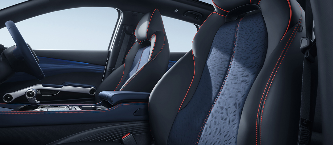 White canvas laptop sleeve with gray felt interior, silver zipper, and tan leather zipper pull.