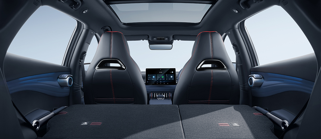 White canvas laptop sleeve with gray felt interior, silver zipper, and tan leather zipper pull.