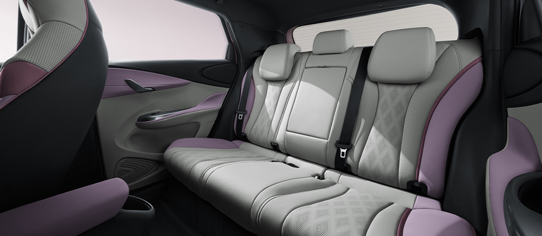 White canvas laptop sleeve with gray felt interior, silver zipper, and tan leather zipper pull.