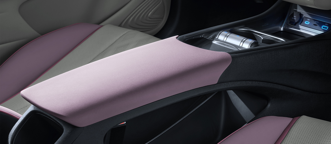 Detail of zipper pull with tan leather and silver rivet.