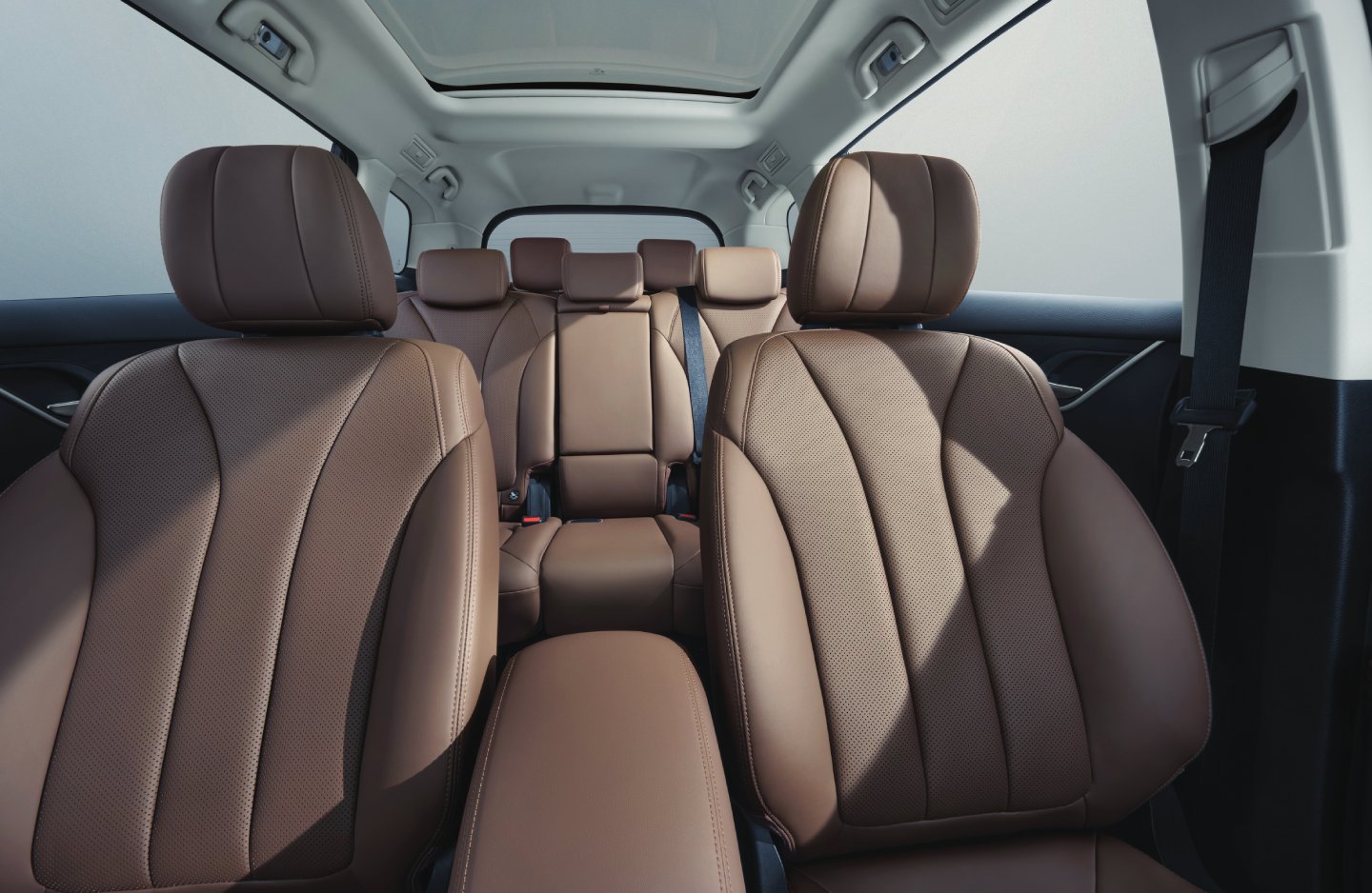 Detail of zipper pull with tan leather and silver rivet.