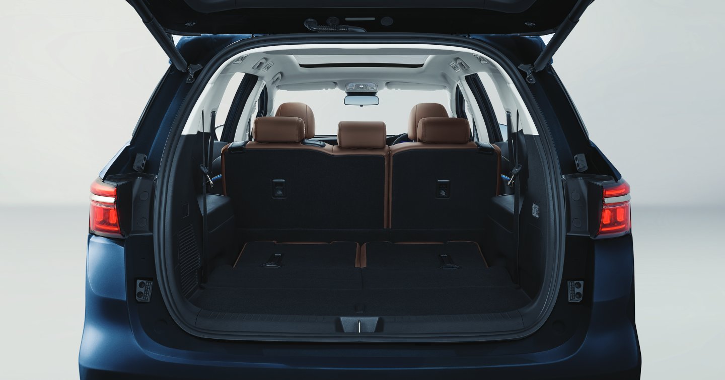 Detail of zipper pull with tan leather and silver rivet.