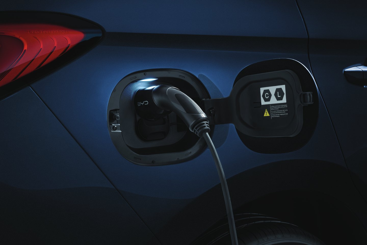 White canvas laptop sleeve with gray felt interior, silver zipper, and tan leather zipper pull.