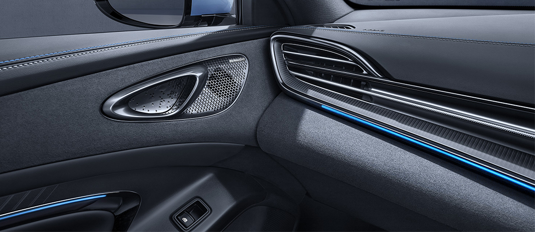 Detail of zipper pull with tan leather and silver rivet.