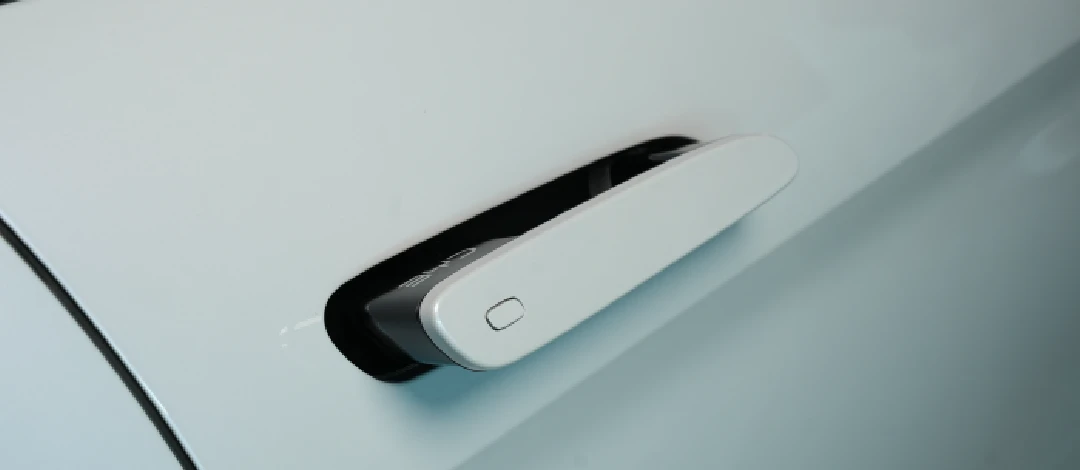 Detail of zipper pull with tan leather and silver rivet.