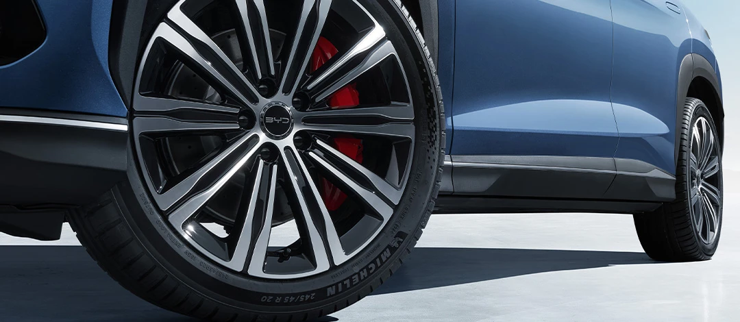 White canvas laptop sleeve with gray felt interior, silver zipper, and tan leather zipper pull.